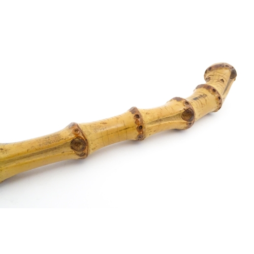 1250 - Two early to mid 20thC Officer's swagger sticks, comprising a leather covered and bamboo examples, t... 