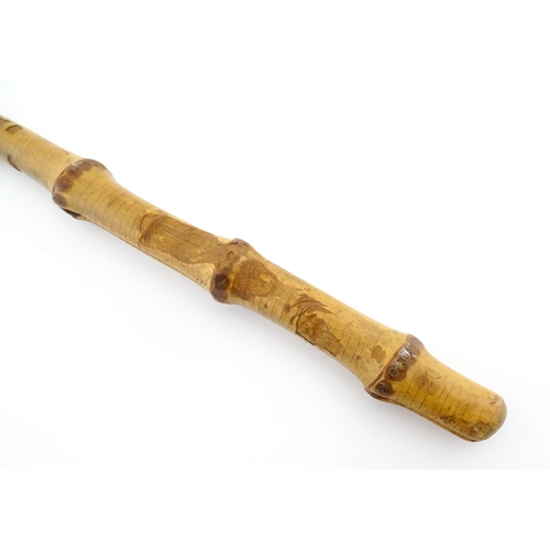 1250 - Two early to mid 20thC Officer's swagger sticks, comprising a leather covered and bamboo examples, t... 