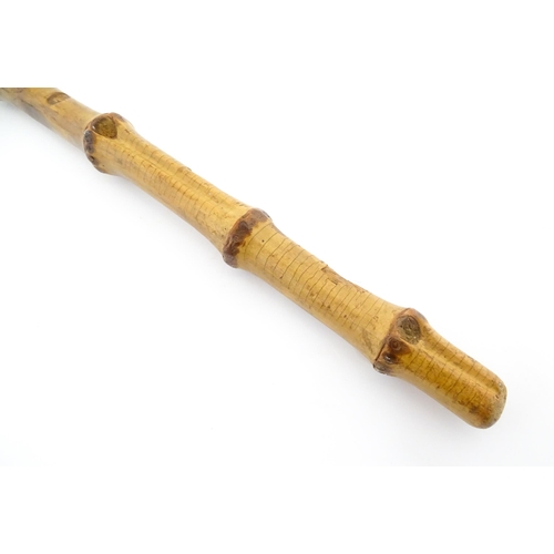 1250 - Two early to mid 20thC Officer's swagger sticks, comprising a leather covered and bamboo examples, t... 