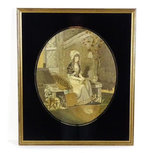 1257 - An early 19thC silkwork embroidery depicting a seated young lady husking seeds. Within a verre eglom... 