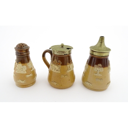 125 - A Royal Doulton two tone stoneware three piece cruet set comprising salt, pepper and mustard, decora... 