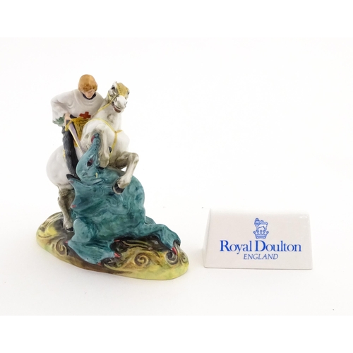 129 - A Royal Doulton figure of St George on horseback slaying the dragon, model no. HN 2051. Together wit... 