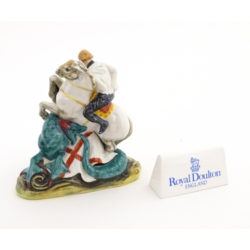 129 - A Royal Doulton figure of St George on horseback slaying the dragon, model no. HN 2051. Together wit... 