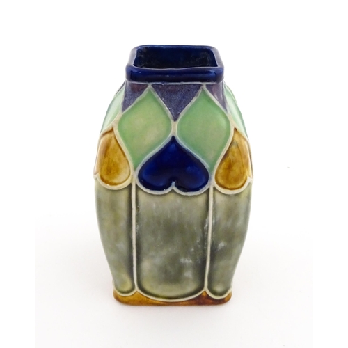 131 - An Art Nouveau Royal Doulton Lambeth stoneware vase of square form with banded heart motifs. Impress... 