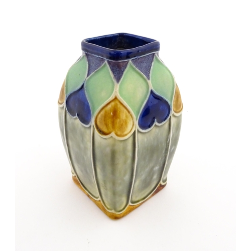 131 - An Art Nouveau Royal Doulton Lambeth stoneware vase of square form with banded heart motifs. Impress... 