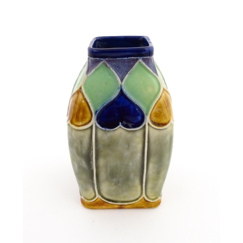 131 - An Art Nouveau Royal Doulton Lambeth stoneware vase of square form with banded heart motifs. Impress... 