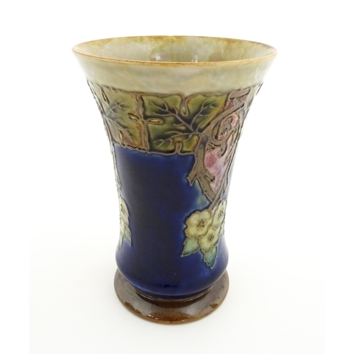 132 - A Royal Doulton stoneware vase with a flared rim, the mottled blue and green glaze with tubelined fl... 