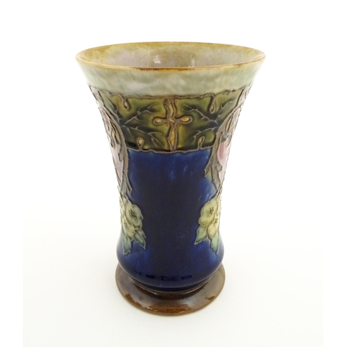 132 - A Royal Doulton stoneware vase with a flared rim, the mottled blue and green glaze with tubelined fl... 