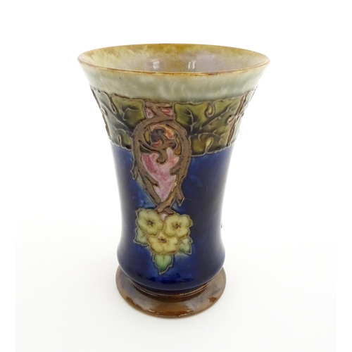 132 - A Royal Doulton stoneware vase with a flared rim, the mottled blue and green glaze with tubelined fl... 