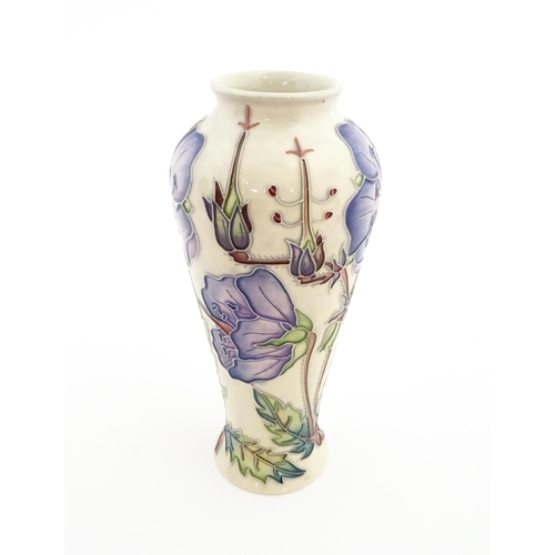 135 - A Moorcroft vase decorated in the Meadow Cranesbill pattern designed by Emma Bossons. Marked under. ... 