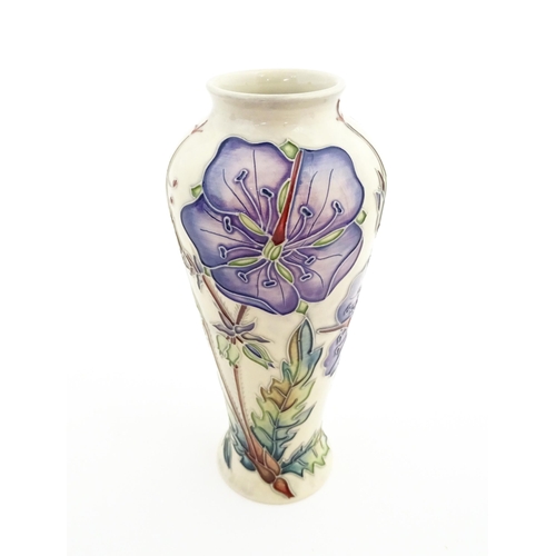 135 - A Moorcroft vase decorated in the Meadow Cranesbill pattern designed by Emma Bossons. Marked under. ... 