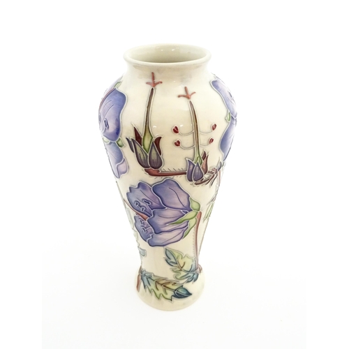 135 - A Moorcroft vase decorated in the Meadow Cranesbill pattern designed by Emma Bossons. Marked under. ... 