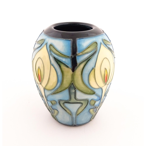 139 - A Moorcroft vase of squat form decorated in the Calla Lily pattern designed by Emma Bossons. Marked ... 