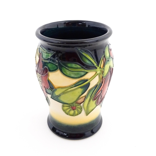 141 - A Moorcroft vase of barrel form decorated in the Kapok Tree. Marked and signed under. Approx. 5 1/2