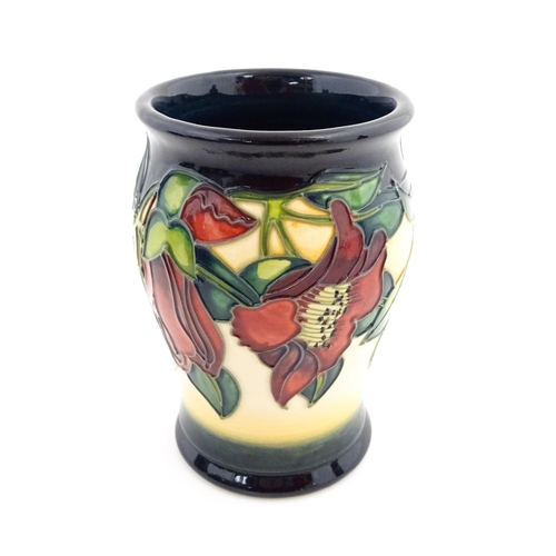 141 - A Moorcroft vase of barrel form decorated in the Kapok Tree. Marked and signed under. Approx. 5 1/2