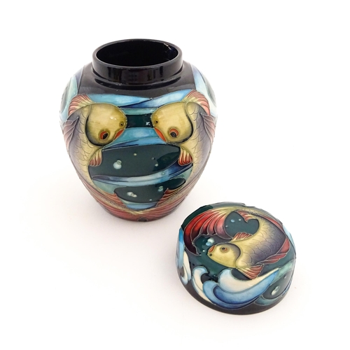 143 - A Moorcroft ginger jar decorated in the Lagoon pattern with fish detail. Marked under with makers ma... 