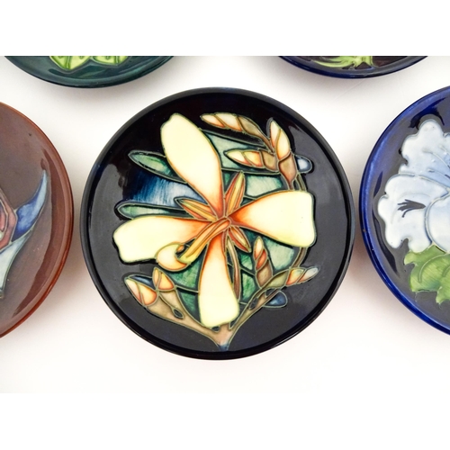 147 - Seven Moorcroft pin dishes / small plates decorated in various patterns to include Sunflower, Finche... 