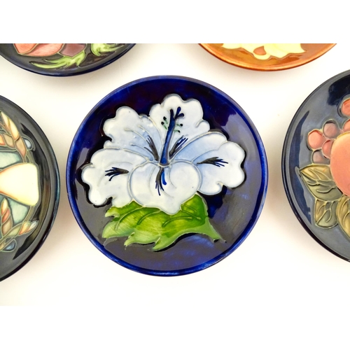 147 - Seven Moorcroft pin dishes / small plates decorated in various patterns to include Sunflower, Finche... 