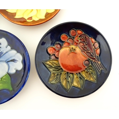 147 - Seven Moorcroft pin dishes / small plates decorated in various patterns to include Sunflower, Finche... 