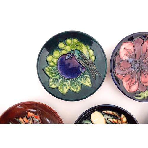 147 - Seven Moorcroft pin dishes / small plates decorated in various patterns to include Sunflower, Finche... 