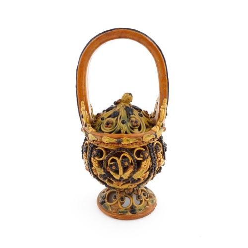 153 - A Continental earthenware fire / charcoal basket in the Flemish style / pot pourri with openwork dec... 