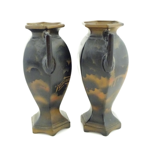 154 - A pair of twin handled vases of hexagonal form with Japanese Geisha decoration. Approx. 12