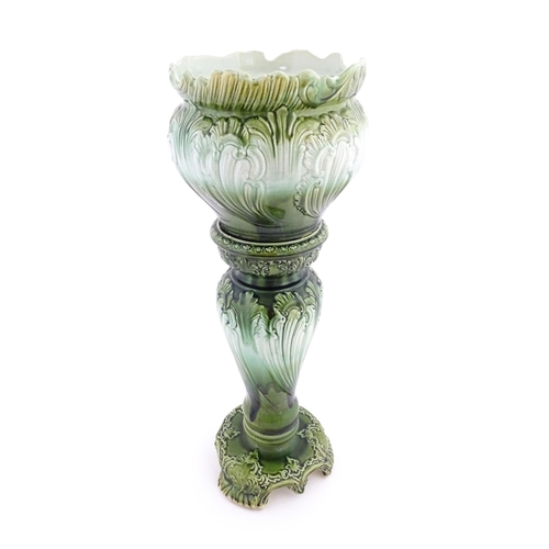 187 - A Victorian jardiniere and stand with green glaze and foliate decoration. Marked under Princess with... 