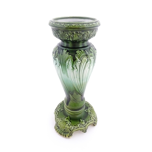 187 - A Victorian jardiniere and stand with green glaze and foliate decoration. Marked under Princess with... 