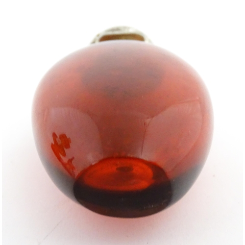 208 - A 19thC cranberry glass scent bottle / perfume flask with white metal top, maker GB. Approx. 3 1/2