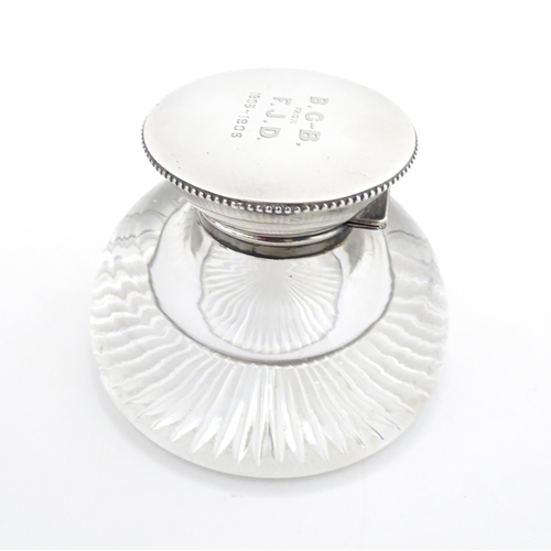 209 - A glass inkwell with silver top hallmarked London 1905 maker James Dudley and stamped J Dudley South... 