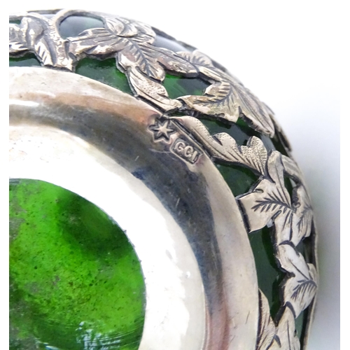 215 - A green glass perfume / scent bottle with white metal floral and foliate overlay in the Oriental sty... 