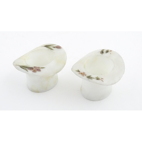 216 - A pair of milk glass match holders / vesta keeps  formed as top hats with hand painted floral detail... 