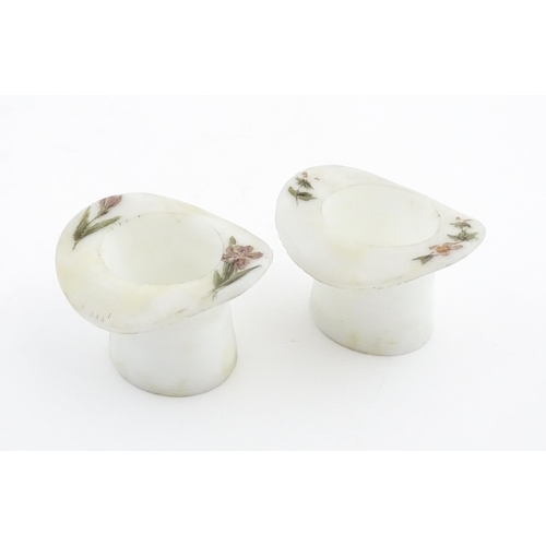 216 - A pair of milk glass match holders / vesta keeps  formed as top hats with hand painted floral detail... 