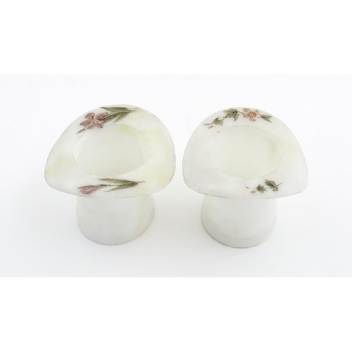 216 - A pair of milk glass match holders / vesta keeps  formed as top hats with hand painted floral detail... 