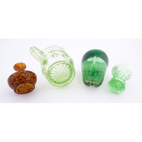 222 - Four items of glassware to include a green sommerso art glass vase, a Uranian green jug, etc. Green ... 