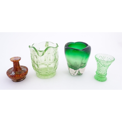 222 - Four items of glassware to include a green sommerso art glass vase, a Uranian green jug, etc. Green ... 