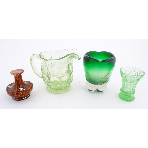 222 - Four items of glassware to include a green sommerso art glass vase, a Uranian green jug, etc. Green ... 