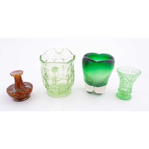 222 - Four items of glassware to include a green sommerso art glass vase, a Uranian green jug, etc. Green ... 