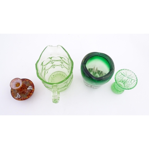 222 - Four items of glassware to include a green sommerso art glass vase, a Uranian green jug, etc. Green ... 