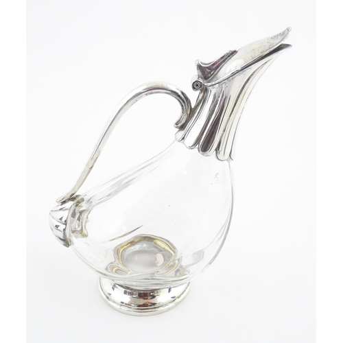 223 - A late 20thC glass claret jug of stylised duck form with silver plate mounts. Approx. 9 3/4