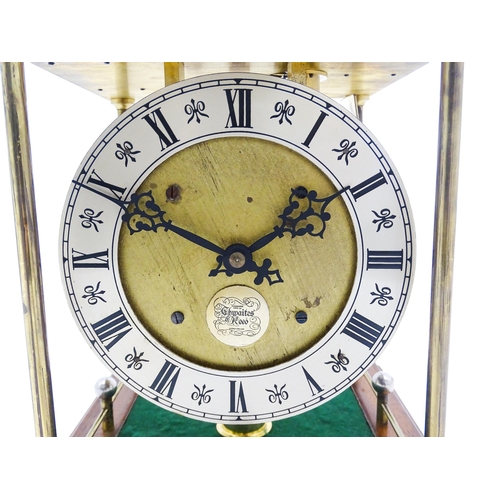 1434 - A Thwaites & Reed rolling ball clock, the open movement with silvered dial with Roman numerals and n... 