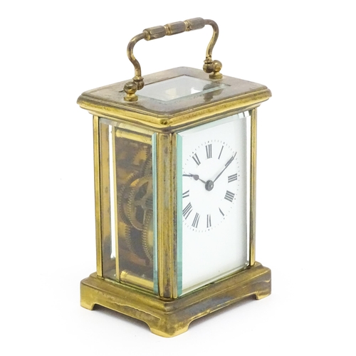 1435 - A brass carriage clock with French movement and with white enamel dial  having Roman numerals. Appro... 