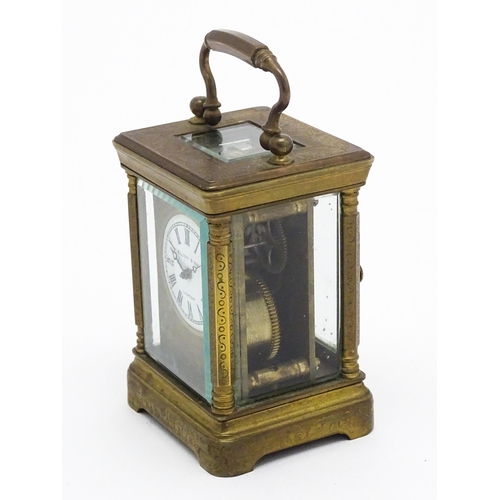 1436 - A small brass carriage clock with white enamel dial with Roman Numerals and signed ' Elliot & Son Lo... 