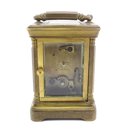 1436 - A small brass carriage clock with white enamel dial with Roman Numerals and signed ' Elliot & Son Lo... 