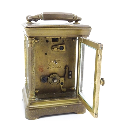 1436 - A small brass carriage clock with white enamel dial with Roman Numerals and signed ' Elliot & Son Lo... 