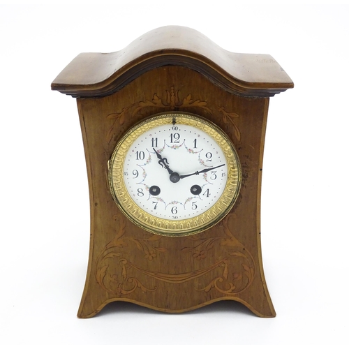 1437 - A late 19thC / early 20thC  mahogany cased French mantle clock with satinwood inlay and white enamel... 