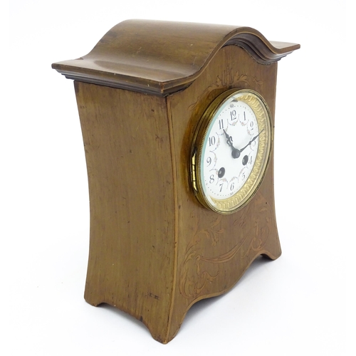 1437 - A late 19thC / early 20thC  mahogany cased French mantle clock with satinwood inlay and white enamel... 