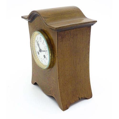 1437 - A late 19thC / early 20thC  mahogany cased French mantle clock with satinwood inlay and white enamel... 