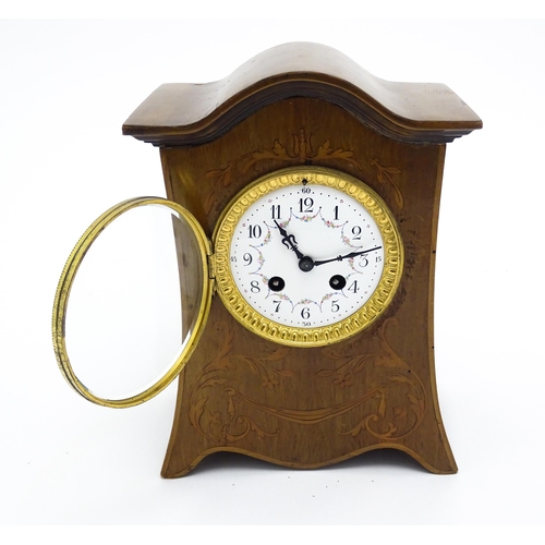 1437 - A late 19thC / early 20thC  mahogany cased French mantle clock with satinwood inlay and white enamel... 