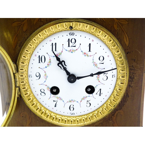 1437 - A late 19thC / early 20thC  mahogany cased French mantle clock with satinwood inlay and white enamel... 